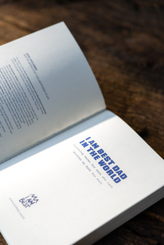 Open book with a page displaying 'I am the best dad in the world' in blue text.