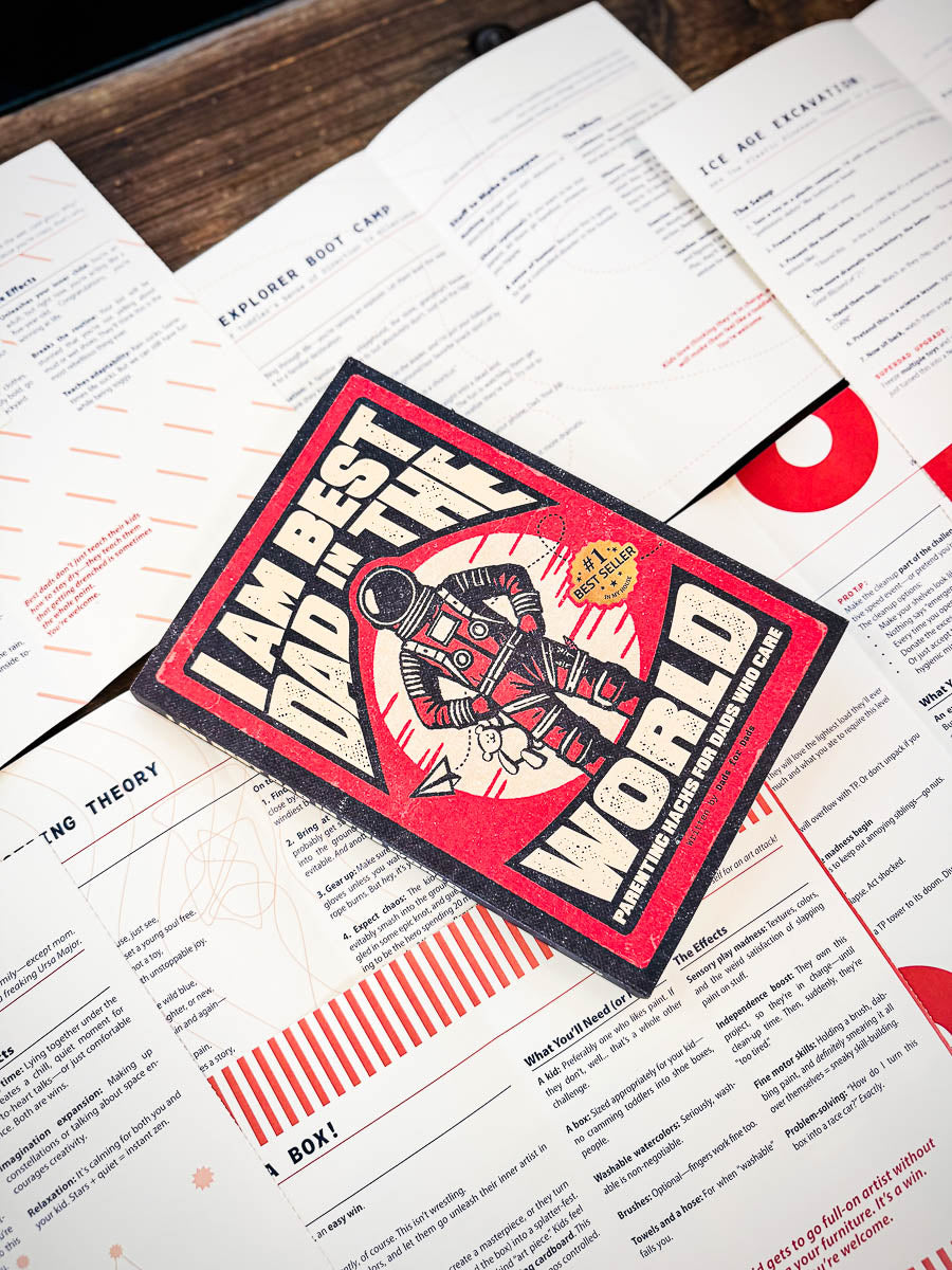 Patch with text 'I am best dad in the world' on top of printed pages.
